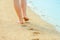 A beautiful footprints in the sand by the sea background