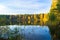 Beautiful forest lake old quarry on a clear autumn day