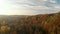 Beautiful forest scene in autumn with orange and yellow foliage. Aerial early morning view of trees and river. Fall city park scen