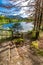 Beautiful forest stairs leading to the lake in the Alps