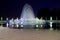 Beautiful fountain at night against blue sky. Evening view of Dnipro city. Creative water design, arched fountain, elegant