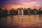 Beautiful fountain over silhouette public park before dusk