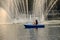 Beautiful fountains in the lake at Lumpini Park, Bangkok Thailand. Tranquil public park garden with pond, fountain, and boats in