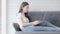 Beautiful freelance young asian woman working online laptop happy sitting on couch at living room