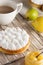 Beautiful freshly made white lemon meringue tart on plate. Lemon meringue pie still life composition. Food photo