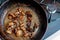 Beautiful fried mushrooms champignon in background cast iron pan