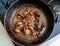 Beautiful fried mushrooms champignon in background cast iron pan