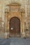 Beautiful Front Facade Of The Church Of Alcala De Henares University With A Nest Of Storks In Its Old Bell Tower. Architecture Tra