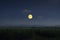 Beautiful full moon over corn farm in the evening