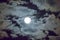 Beautiful full moon and white cloudy sky background in the midnight sky background, moonlight on Halloween night without stars.