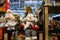 Beautiful funny white snowmen and dolls in red hats. Favorite Christmas and New Year s toys and decorations in the store. Festive