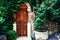 Beautiful garden with old antique door, flowers and ivy. Vintage