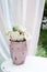 Beautiful garden vase with white roses and other flowers on the table, exterior, gazebo decor idea.