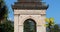 Beautiful Garden Viewed Through A Carved White Triumphal Arch