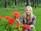 Beautiful gardener woman with red flower