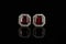 Beautiful garnet earrings with diamonds in a gold chain on a black background