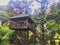 A beautiful gazebo tucked into the corner of a backyard, deck made of wood