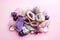 Beautiful gemstones,  geode amethyst and druses of natural purple mineral amethyst on a pink background. Amethysts and rose quartz