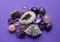 Beautiful gemstones,  geode amethyst and druses of natural purple mineral amethyst on a purple background. Amethysts and rose