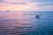 Beautiful gently waves, texture ripple marks, and traditional fish trap in surf. Thailand. Long exposure. Fantastic sunset sky and