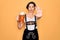 Beautiful german woman with blue eyes wearing traditional octoberfest dress drinking jar of beer with open hand doing stop sign