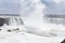Beautiful gigantic frozen Horseshoe Niagara Waterfalls on a frozen spring day in Niagara Falls in Ontario, Canada