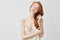 Beautiful ginger girl in sleepwear smiling with closed eyes.