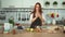 Beautiful Ginger Woman Food Preparation in Kitchen. Red head girl.