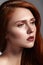 Beautiful ginger young woman with luxury hair style and fashion gloss makeup. Beauty closeup model with red hair