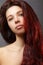 Beautiful ginger young woman with luxury hair style and fashion gloss makeup. Beauty closeup model with red hair