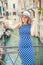 Beautiful gir traveler tourist in blue polka dot dress make selfie in venice Italy. Attractive blonde fashion model young woman