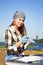 Beautiful girl archaeologist carefully clears the find with a brush