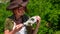 A beautiful girl archaeologist examines the skull of a domestic pig or wild boar near the settlements of ancient people.