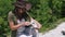 Beautiful girl archaeologist inspects the skull of a domestic sheep or goat near the settlements of ancient people.