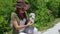 Beautiful girl archaeologist inspects the skull of a domestic sheep or goat near the settlements of ancient people.