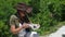 Beautiful girl archaeologist inspects the skull of a domestic sheep or goat near the settlements of ancient people.