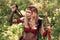 Beautiful girl archer with long blond hair with a bow and arrows dressed in leather