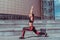 Beautiful girl athlete doing lunges exercises yoga balance concentration, summer in the city. Sportswear Leggings Top