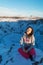 Beautiful girl on the background of lake Kerid frozen in winter in the crater of an extinct volcano. Incredible iceland landscape