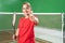 Beautiful girl badminton player with thumbs up holding racket