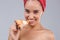 Beautiful girl,with bare shoulders and with a towel on her head, appetizingly eating a slice of pizza.