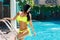 beautiful girl in bikini at the pool in the hotel. Summer v