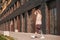 Beautiful girl with bionic prosthesis walking down the street in summer