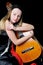 Beautiful girl in black kerchief with a guitar