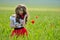 Beautiful girl on blooming poppy field