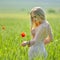 Beautiful girl on blooming poppy field