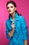 Beautiful girl in blue suit on pink background with creative make-up and fashionable style. Beauty face.