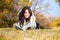 Beautiful girl with book lying on grass