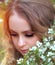 Beautiful girl with a bouquet of flowers in a cherry garden, young, romantic. Close-up. Fashion and beauty concept