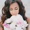 Beautiful girl with a bouquet of peonies